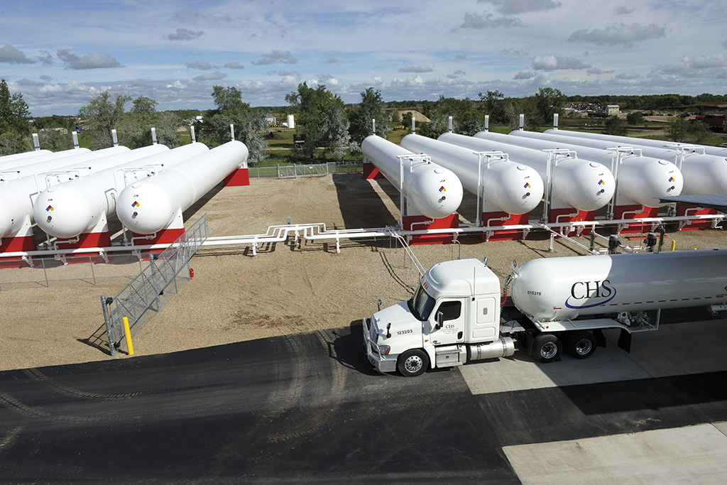 Line of propane tanks with a semi in front of them.